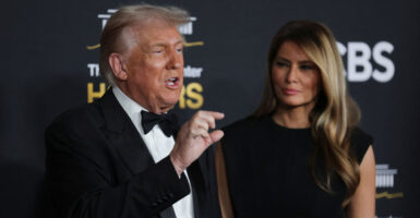 Donald and Melania Trump on red carpet for Kennedy Center Honors. Trump in a tux and Melania in a black gown.