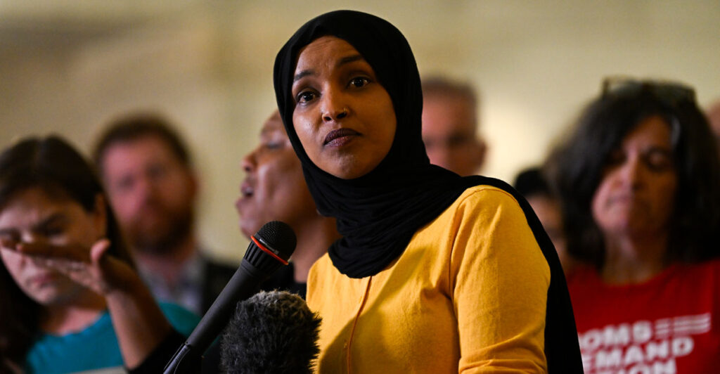 Ilhan Omar in a yellow blouse.