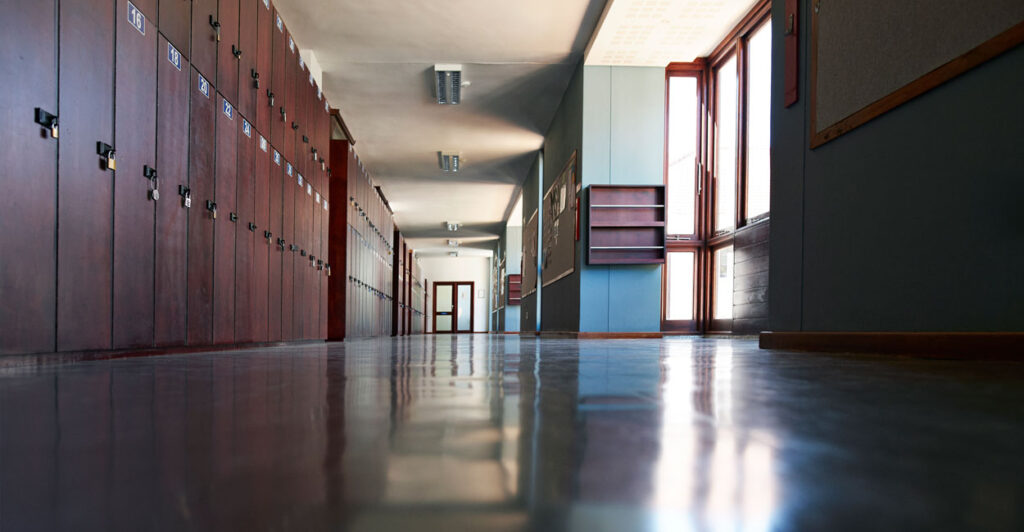 A look down an empty school hallway lined with lockers.