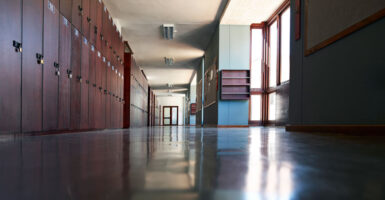 A look down an empty school hallway lined with lockers.