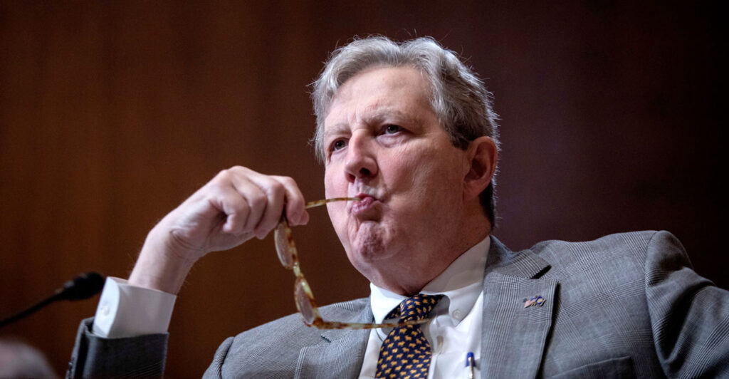 Sen. John Kennedy chews on the end of his eyeglasses during a hearing.