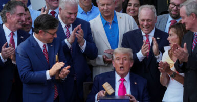 President Trump with gavel, surrounded by top Republicans at signing of One Big Beautiful Bill.