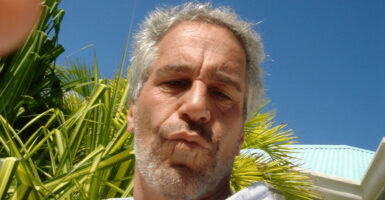 Close-up of Jeffrey Epstein, with pursed lips.