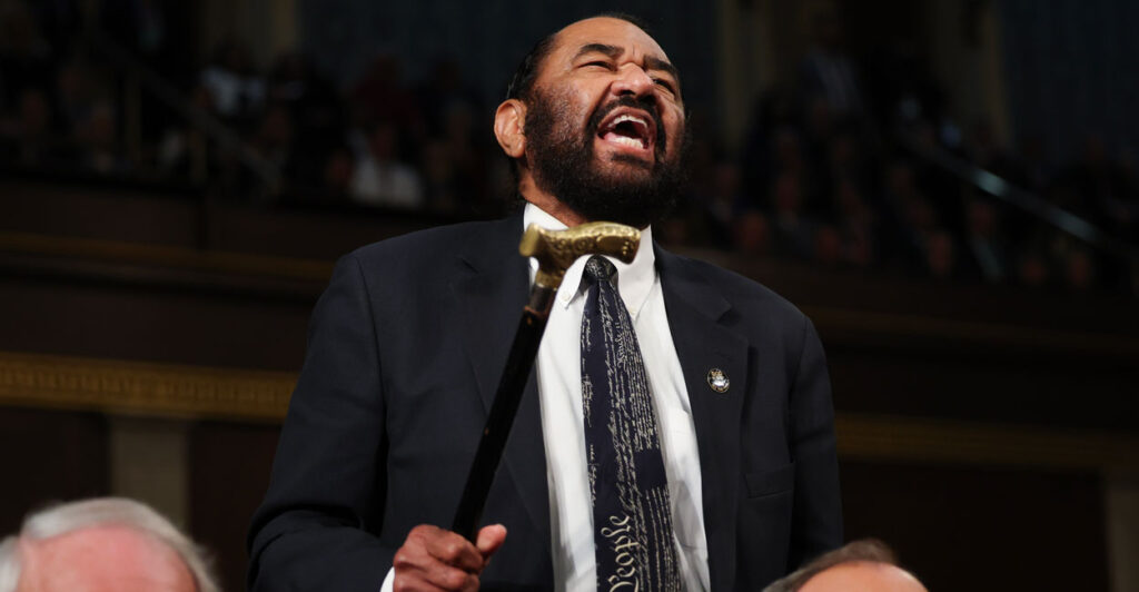 Al Green waves his cane in the House of Representatives.