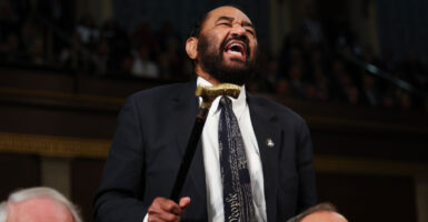 Al Green waves his cane in the House of Representatives.