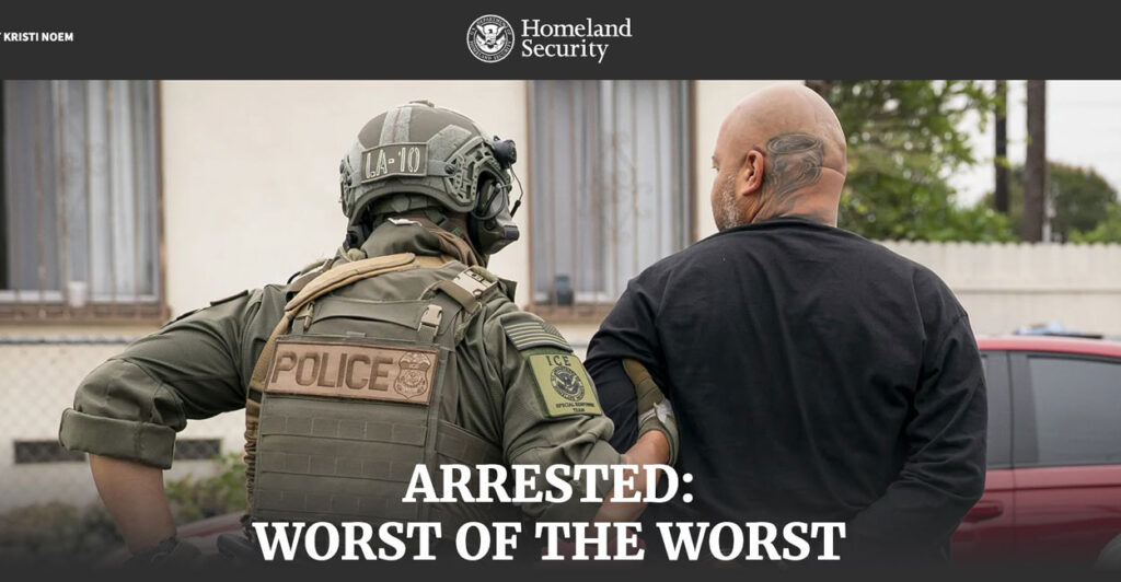 An officer leads away a criminal illegal alien in handcuffs.