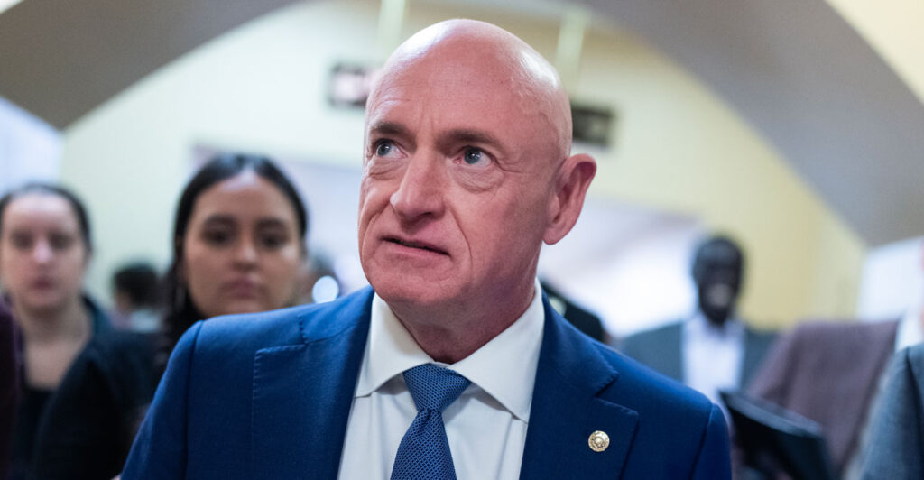 Senator Mark Kelly speaks to reporters in the capitol.