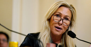 Marjorie Taylor Greene sits in capitol commitee.