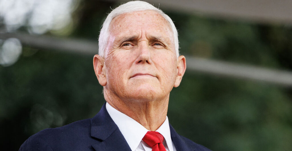 Mike Pence stands outside in a suit and tie.