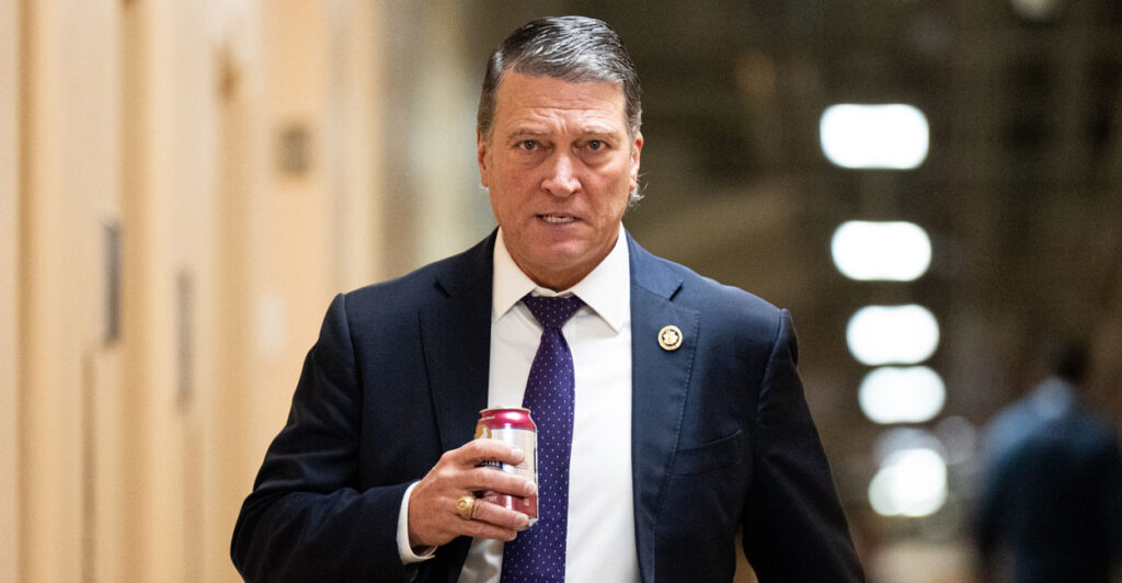 Ronny Jackson walks through a capitol hallway