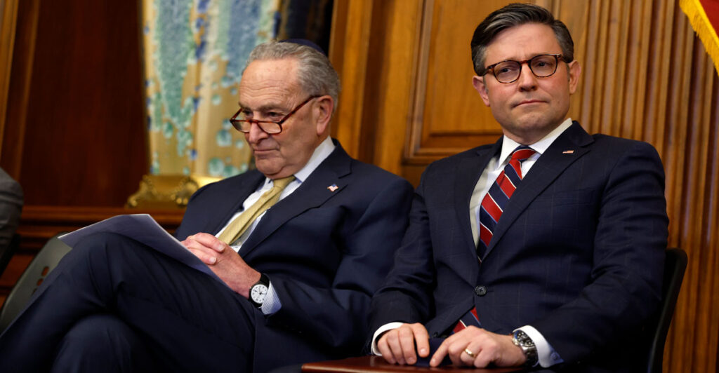 Senate Minority Leader Chuck Schumer and Speaker of the House Mike Johnson sit together at a Hannukah celebration in the Capitol.