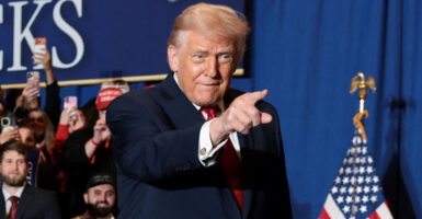 President Donald Trump points during a rally. He suggested he supports Sen. Mike Crapo's alternative to Obamacare subsidies.