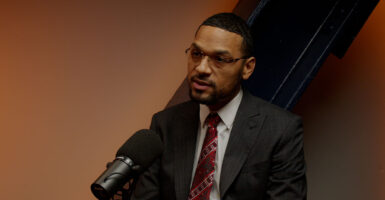 State Rep. Josh Williams speaks into a microphone.