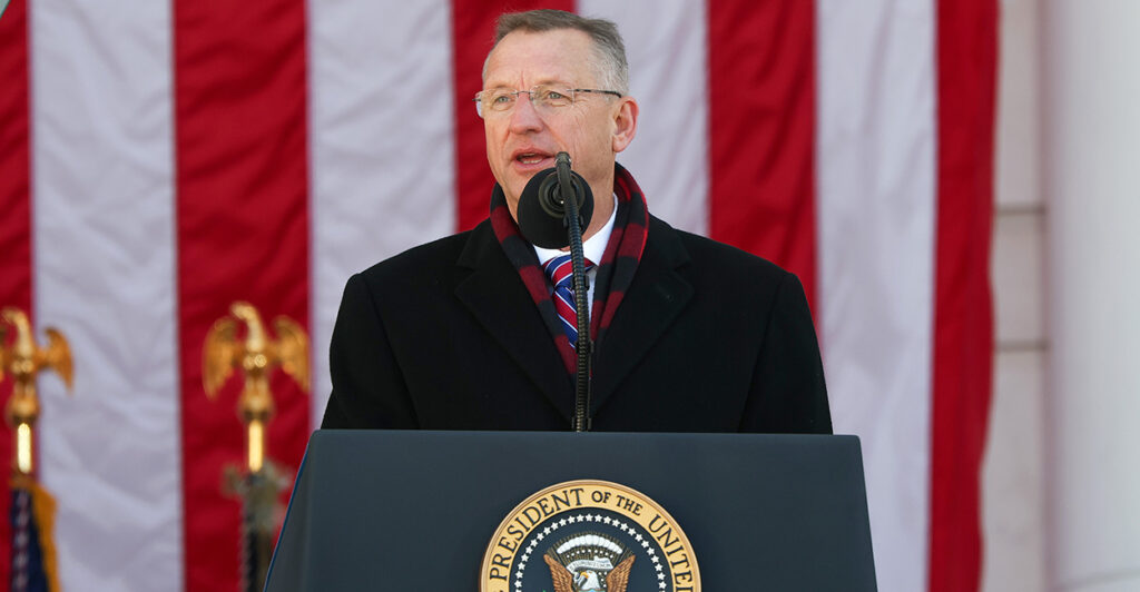 Veterans Affairs Secretary Doug Collins speaks at a podium in front of American flag.