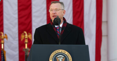 Veterans Affairs Secretary Doug Collins speaks at a podium in front of American flag.