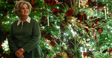 Susie Wiles poses next to a beautiful Christmas tree.