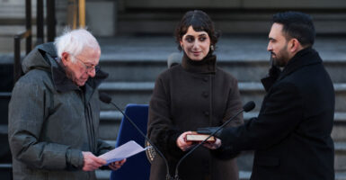 Zohran Mamdani is sworn-in as NYC mayor by socialist Bernie Sanders as his wife looks on, holding a Koran.