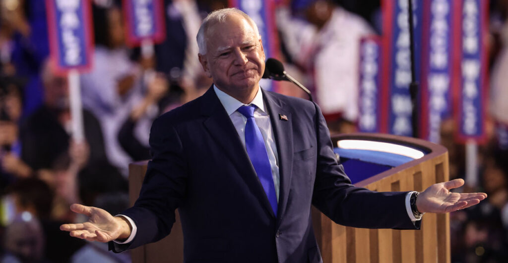 Tim Walz with his arms outstretched at DNC convention.