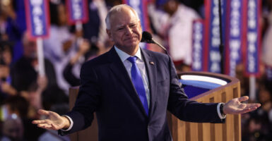 Tim Walz with his arms outstretched at DNC convention.