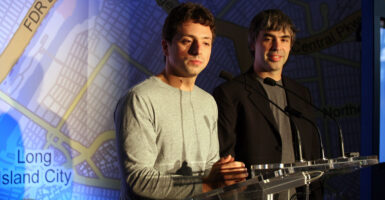 Google founders Google founders Larry Page and Sergey Brin sit at a table in front of a New York road map.