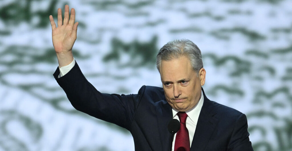 David Sacks on stage, waving.