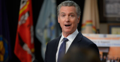 Gavin Newsom in a suit with his mouth wide open.