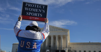WASHINGTON, DC - JANUARY 13: Protesters against transgender athletes competing in women's sports gather outside the Supreme Court on January 13, 2026 in Washington, DC. Groups from both sides of the debate gathered on Tuesday morning to protest while two cases that prohibit transgender girls from joining girls' and women's sports teams are heard inside the Supreme Court. Heather Diehl/Getty Images