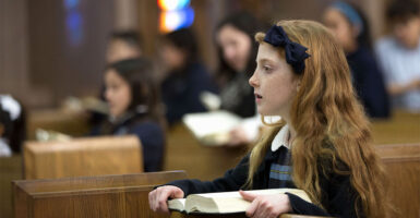 Ten year old schoolgirl at daily church service.