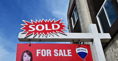 A 'sold' sign is seen on a house in Monterey Park, California, on September 17, 2025. The US Federal Reserve on September 17 lowered interest rates for the first time this year, flagging slower job gains and risks to employment as policymakers face heightened pressure under President Donald Trump. (Photo by Frederic J. BROWN / AFP) (Photo by FREDERIC J. BROWN/AFP via Getty Images)