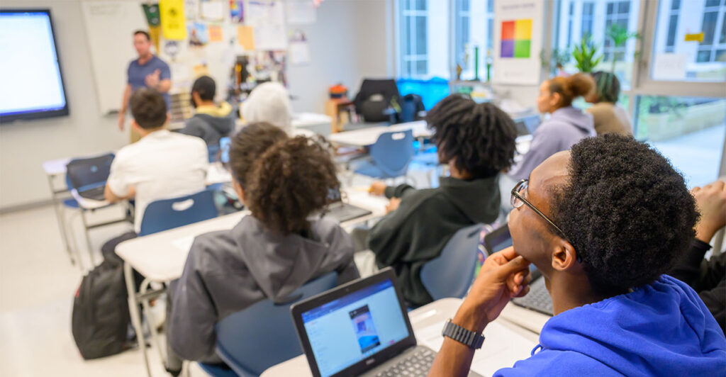 An Albany High School student listens as business teacher Christhoper Austen goes through different investment strategies for students who received a fictional $2,000 graduation present during a class on Friday, Nov. 7, 2025, in Albany, NY. (Jim Franco/Times Union via Getty Images)