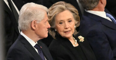 Former US President Bill Clinton and former Secretary of State Hillary Clinton speak as they attend the State Funeral Service for former US President Jimmy Carter at the Washington National Cathedral in Washington, DC, on January 9, 2025. (Photo by Mandel NGAN / AFP) (Photo by MANDEL NGAN/AFP via Getty Images)