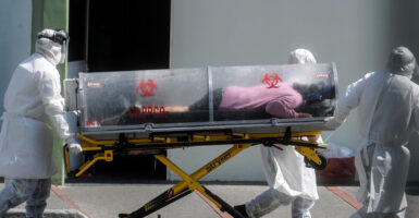 TOPSHOT - Paramedics move a patient suspected of being infected with the novel coronavirus into the 22 Battalion of the Military Police Hospital, in Mexico City, on December 30, 2020. (Photo by PEDRO PARDO / AFP) (Photo by PEDRO PARDO/AFP via Getty Images)