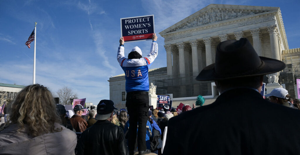 A man holds up a sign reading "Protect women's sports" as he demonstrates outside the US Supreme Court.