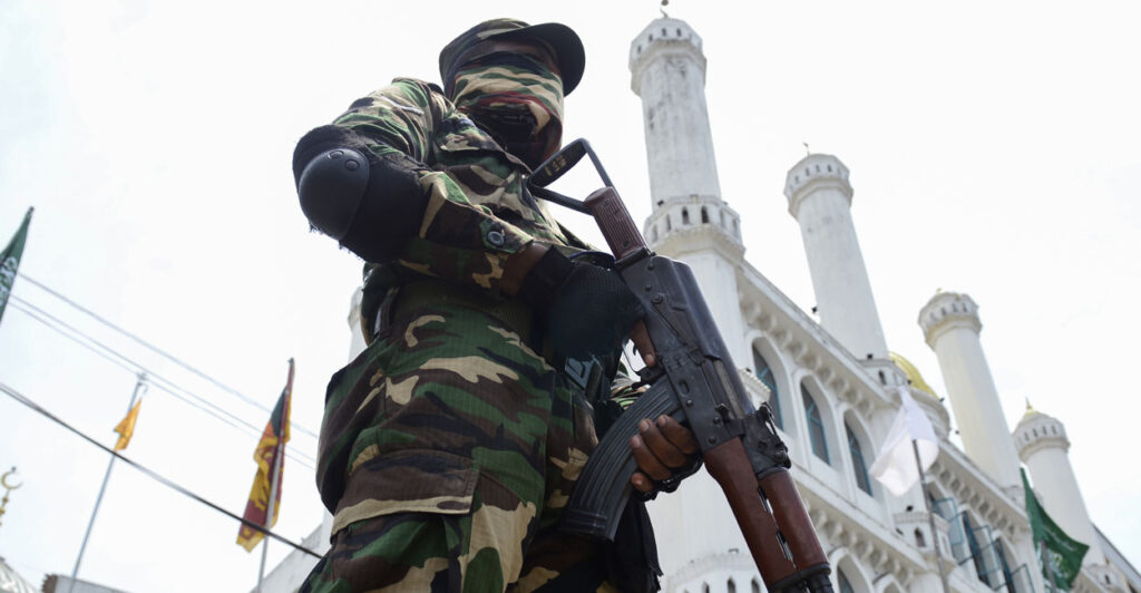 Security personnel stands guard outside a mosque.