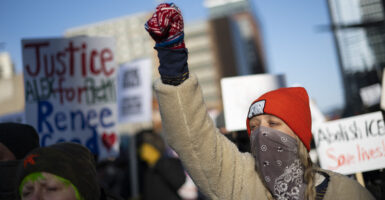 TOPSHOT - Protesters against Immigration and Customs Enforcement (ICE) march through the streets of downtown Minneapolis, Minnesota, on January 25, 2026. On January 24, federal agents shot dead US citizen Alex Pretti, a 37-year-old ICU nurse, while scuffling with him on an icy roadway, less than three weeks after an immigration officer shot and killed Renee Good, also 37, in her car. His killing sparked new protests and impassioned demands by local leaders for the Trump administration to end its operation in the city. (Photo by ROBERTO SCHMIDT / AFP via Getty Images)