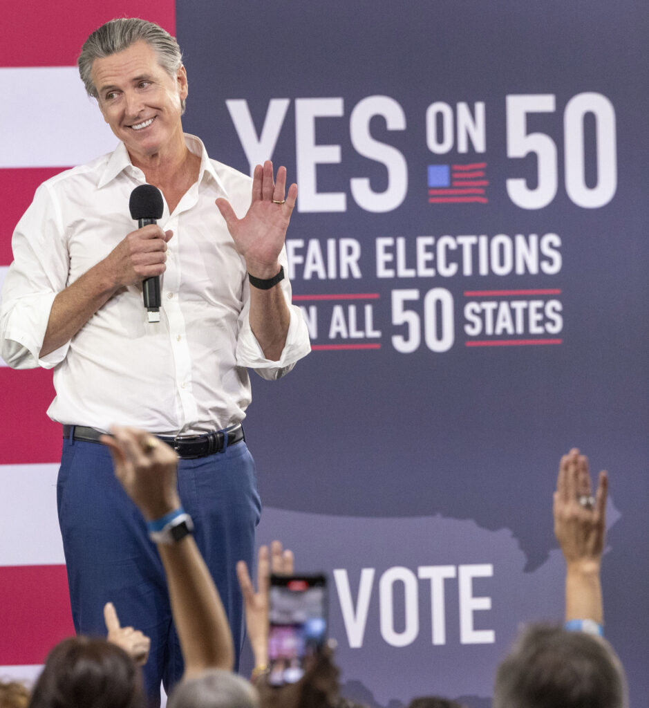 California Governor Gavin Newsom speaks at a "Yes On Prop 50" volunteer event .
