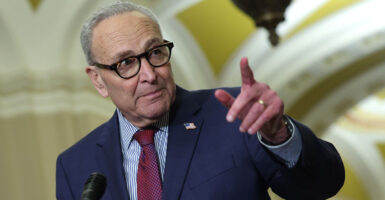 Sen. Chuck Schumer points as he speaks to reporters at a Capitol press conference.