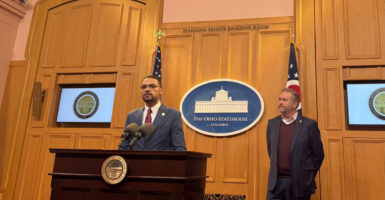 State Rep. Josh Williams, R-Ohio, speaks at the podium during a press conference at the Ohio Statehouse as Attorney General Dave Yost stands off to the side.