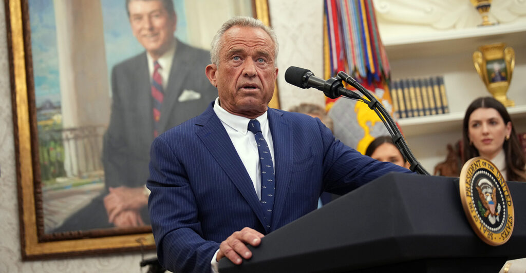 HHS Secretary Robert F. Kennedy, Jr. at a podium.