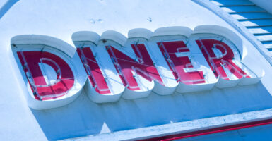 A red "DINER" sign against a white background,