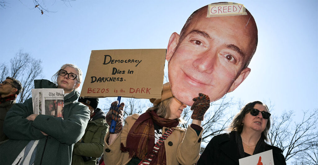Washington Post employees, along with supporters from the Washington-Baltimore News Guild and members of the public, rally outside the Washington Post office building in Washington, DC, on Feburary 5, 2026. The Washington Post, owned by billionaire Amazon founder Jeff Bezos, announced major job cuts on February 4, saying that "painful" restructuring was needed at the storied newspaper. The Post, which gained legendary status when its reporting helped bring down president Richard Nixon in the Watergate scandal, will see "substantial" reductions in its newsroom, Executive Editor Matt Murray said. (Photo by Oliver Contreras / AFP via Getty Images)