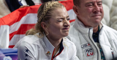 Olympic skater Amber Glenn makes a face as she awaits her disappointing score at the Olympics.