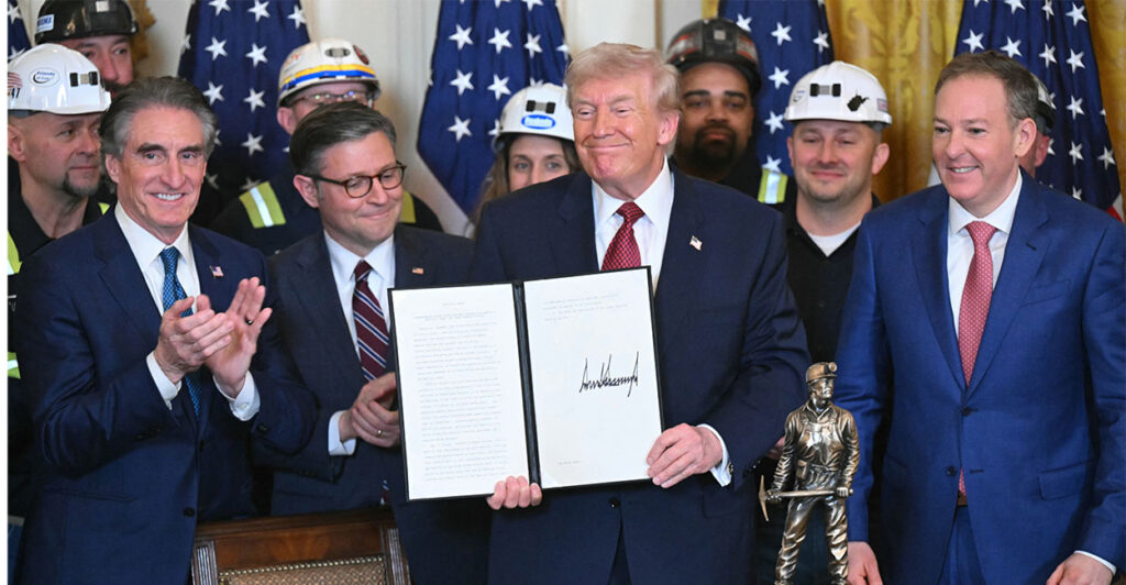 US Secretary of the Interior Doug Burgum, House Speaker Mike Johnson and EPA Administrator Lee Zeldin atans with US President Donald Trump holding a signed executive order directing the military to purchase electricity from coal-fired power plants during a "Champion of Coal" event at the White House in Washington, DC, on February 11, 2026. (Photo by SAUL LOEB / AFP via Getty Images)