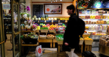People shop for fruit in a grocery store in the Manhattan borough of New York City on December 13, 2025. (Photo by CHARLY TRIBALLEAU / AFP via Getty Images)