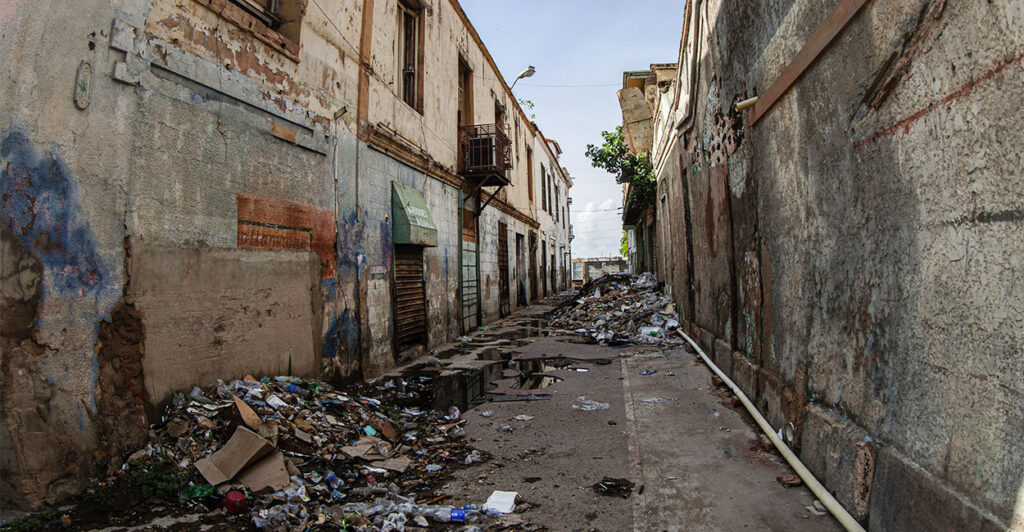 Maracaibo, Venezuela. The historic center of the oil capital of Maracaibo, the commercial center of the state of Zulia. Following oil exploitation, with the Dutch company Shell and the American Creole Petroleum Corporation, the local economy began to boom, local merchants establishing themselves and maintaining commercial activity in Baralt Square and its surrounding areas for over a century. After the arrival of the late Venezuelan socialist military president, Hugo Chavez, the country's economy suffered severe distortions that led to several devaluations of the Venezuelan currency, the Bolivar, impoverishing the country's merchants. Today, Plaza Baralt and its buildings display the solitude and deterioration, symbolizing how ill-conceived political ideologies lead to the economic decline of people. (Photo by: Jose Bula Urrutia/UCG/Universal Images Group via Getty Images)