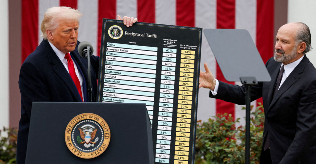 President Donald Trump holds a chart next to U.S. Secretary of Commerce Howard Lutnick as Trump delivers remarks on tariffs in the Rose Garden at the White House in Washington, D.C., U.S., April 2, 2025. REUTERS/Carlos Barria