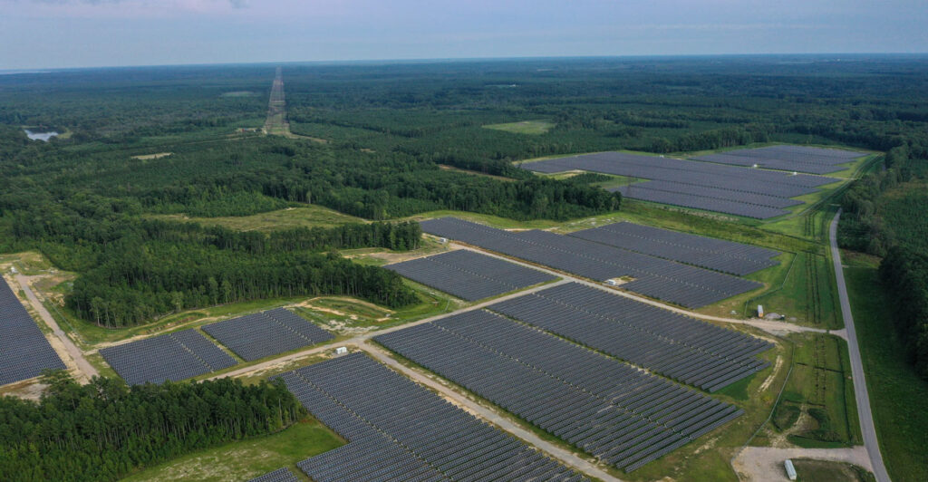 In an aerial view, the Amazon Fort Powhatan Solar Farm is seen on August 19, 2022 in Disputanta, Virginia. Amazon has partnered with Dominion Energy to build over 19 solar farms in the state, which are used to power Amazon Web Services, its cloud-computing service, and eventually its HQ2 location in Northern Virginia once complete. Amazon is the world's largest corporate buyer of renewable energy, with a company pledge to use 100% renewable energy for all of its operations by 2030. (Photo by Drew Angerer/Getty Images)