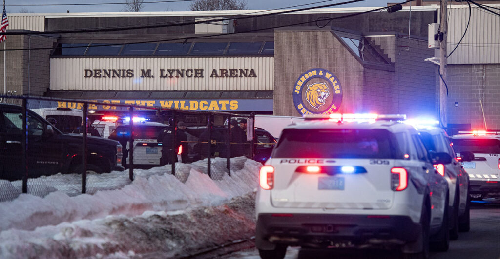 Police stand outside the perimeter they created around the Dennis M. Lynch Arena where a shooting occurred earlier today in Pawtucket, Rhode Island, on February 16, 2026. At least two people were killed and three wounded in a shooting at an ice rink in the northeastern US town of Pawtucket on Monday, authorities said, with social media footage showing frightened teenagers fleeing the sound of gunshots. "We have three deceased. The suspect, and then we have two victims, and then we have three at the hospital," said Pawtucket police chief Tina Goncalves told reporters after the incident. She added that initial investigations suggested the shooting was targeted and "may be a family dispute." (Photo by Joseph Prezioso / AFP via Getty Images)