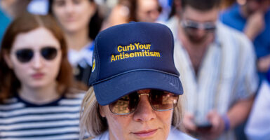 WASHINGTON, DC - MAY 2: A woman wears a hat that reads "Curb Your Antisemitism" during a rally against campus antisemitism at George Washington University on May 2, 2024 in Washington, DC. A pro-Palestinian rally was also held at the school today, as protestors at college campuses around the country call for schools to divest from Israeli interests amid the ongoing war in Gaza. (Photo by Andrew Harnik/Getty Images)