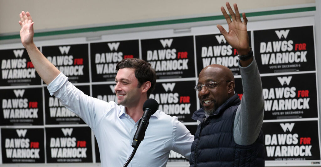 ATHENS, GEORGIA - DECEMBER 04: Georgia Democratic Senate candidate U.S. Sen. Raphael Warnock (D-GA) (R) and Sen. Jon Ossoff (D-GA) wave to students before speaking at a Dawgs for Warnock rally at the University of Georgia December 4, 2022 in Athens, Georgia. Sen. Warnock continues to campaign throughout Georgia for the runoff election on December 6 against his Republican challenger Herschel Walker. (Photo by Win McNamee/Getty Images)